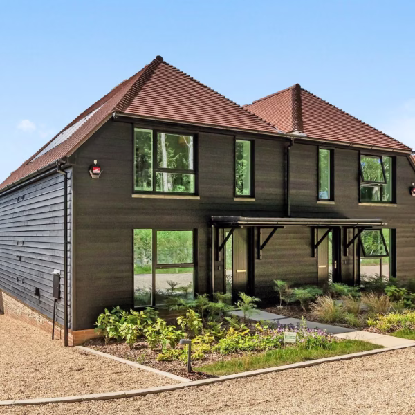 Front elevation with brick, flint and dark timber cladding